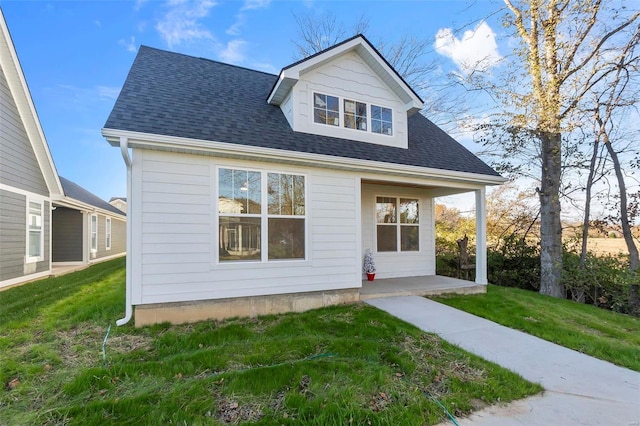 rear view of house with a yard