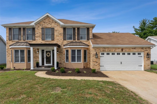 view of front of home featuring a front yard and a garage