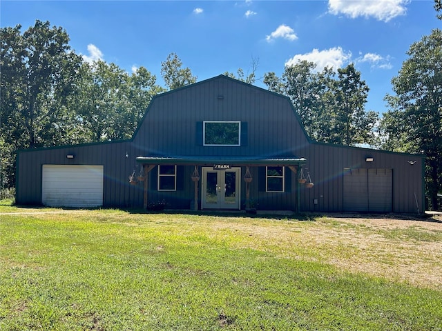 view of outdoor structure with french doors and a lawn