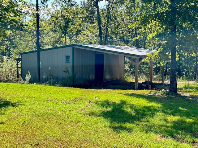 view of outdoor structure featuring a lawn