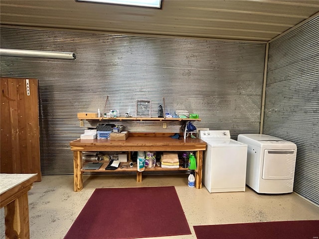 washroom with independent washer and dryer and a workshop area