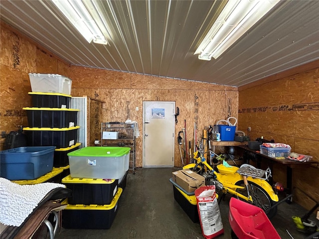 garage featuring wood walls