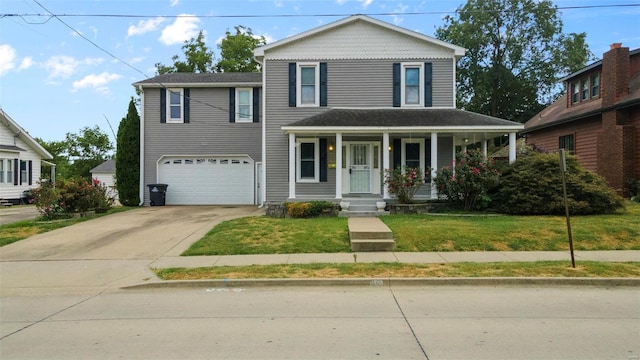 front of property featuring a garage, a front lawn, and covered porch