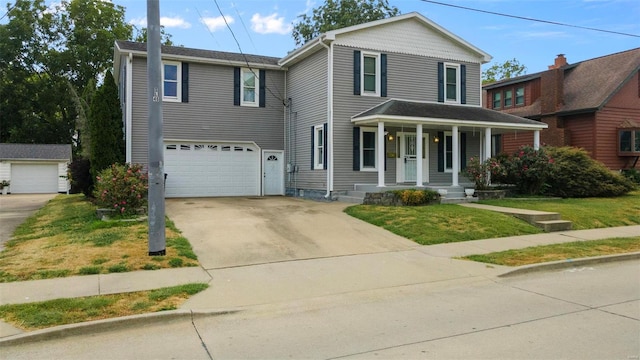 view of property featuring a garage, a front yard, and a porch