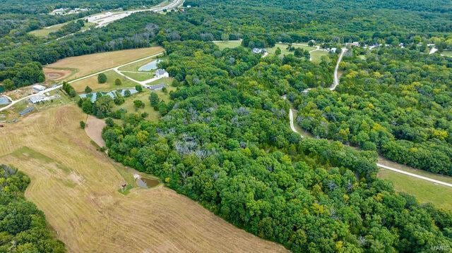 birds eye view of property featuring a wooded view