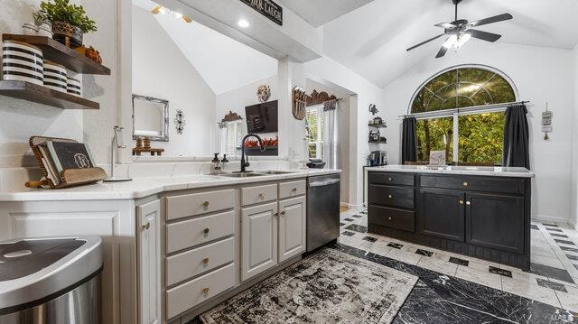 bathroom with vanity, ceiling fan, and high vaulted ceiling