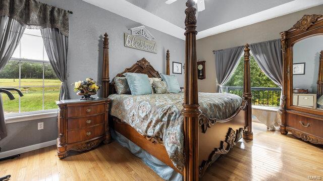 bedroom with wood-type flooring and ceiling fan