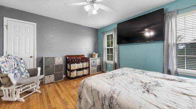 bedroom with a ceiling fan and wood finished floors