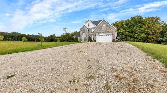 view of front of property with a garage and a front lawn