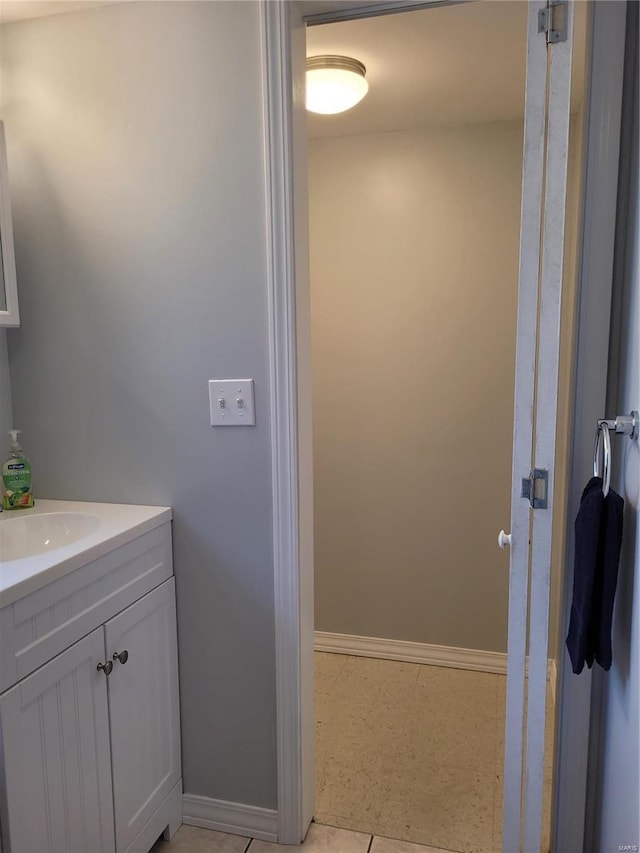 bathroom featuring vanity, baseboards, and tile patterned floors