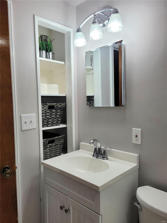 bathroom featuring vanity and toilet