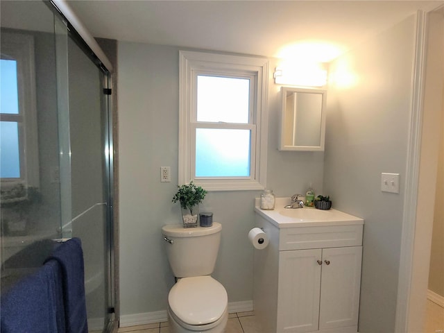 bathroom with baseboards, toilet, tile patterned flooring, vanity, and a shower stall