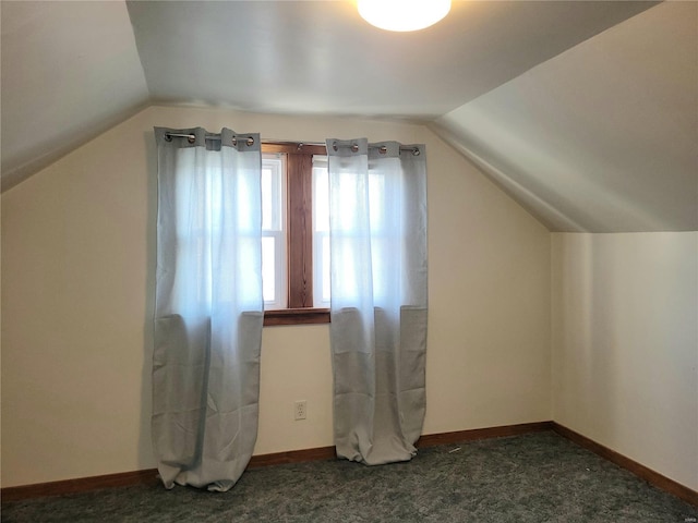 bonus room with lofted ceiling, carpet, and baseboards