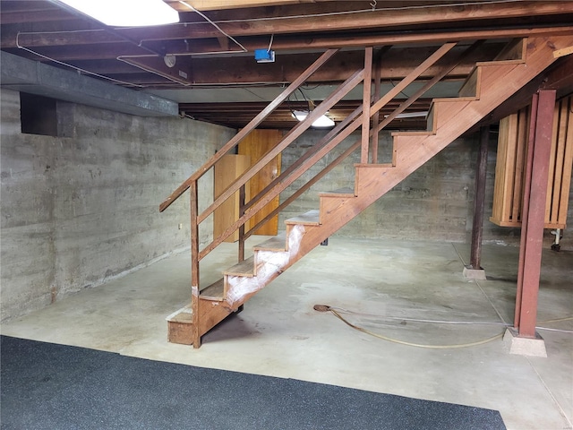 unfinished basement featuring stairway