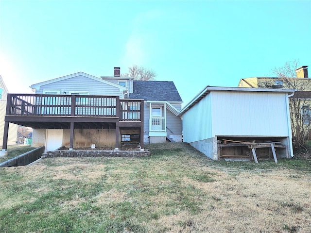 rear view of house featuring a yard, a chimney, and a wooden deck