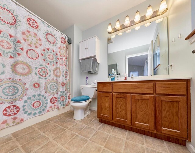 bathroom with walk in shower, vanity, and toilet