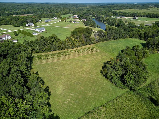 birds eye view of property with a water view and a rural view