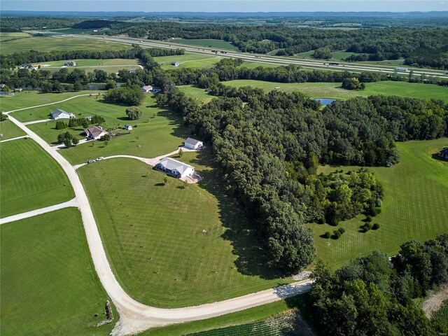 birds eye view of property featuring a water view and a rural view