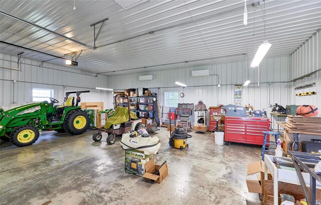 garage featuring a garage door opener and a workshop area