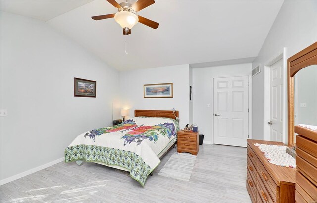 bedroom featuring ceiling fan, light hardwood / wood-style floors, and vaulted ceiling