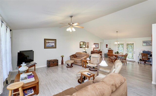 living room with ceiling fan, lofted ceiling, and light hardwood / wood-style flooring