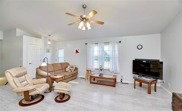 living room with light hardwood / wood-style floors and ceiling fan