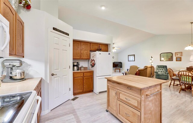 kitchen with light hardwood / wood-style floors, vaulted ceiling, ceiling fan with notable chandelier, white appliances, and pendant lighting