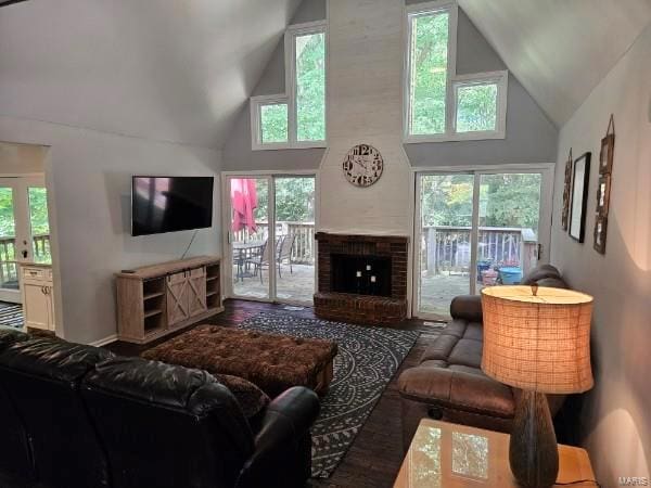 living room featuring high vaulted ceiling and a fireplace