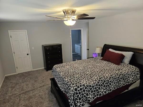 bedroom featuring carpet, ensuite bath, and ceiling fan