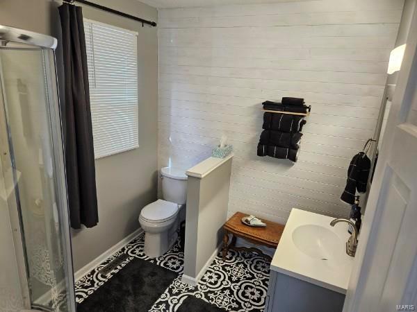 bathroom featuring tile patterned flooring, toilet, and vanity