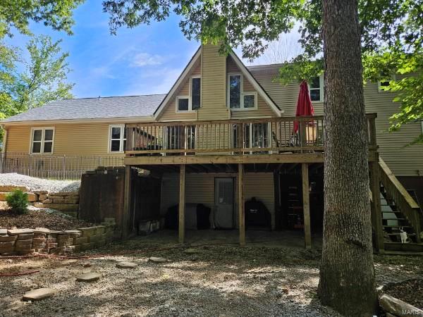 back of property featuring a deck