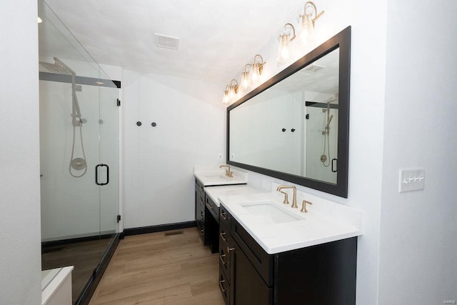 bathroom featuring vanity, hardwood / wood-style floors, and an enclosed shower