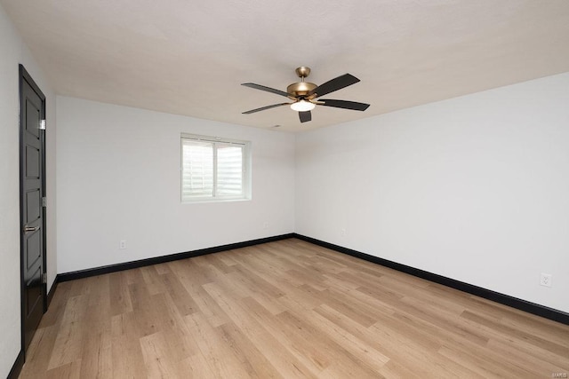 spare room featuring light hardwood / wood-style flooring and ceiling fan