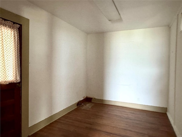 empty room featuring baseboards and wood finished floors