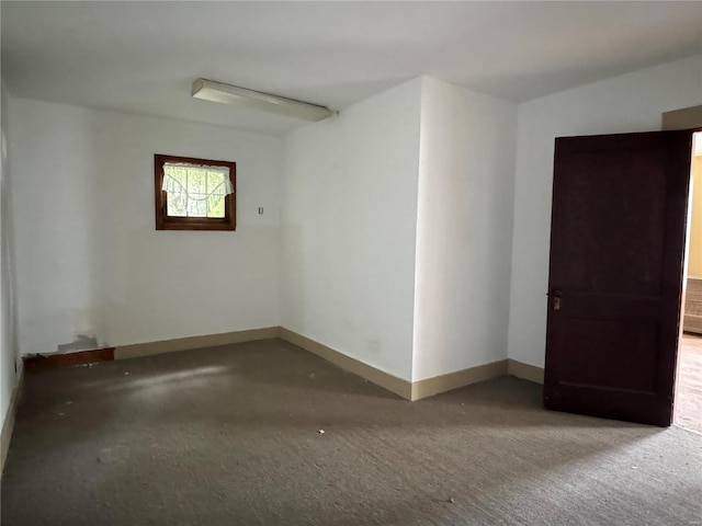 spare room with baseboards