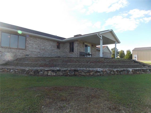 rear view of house featuring a lawn