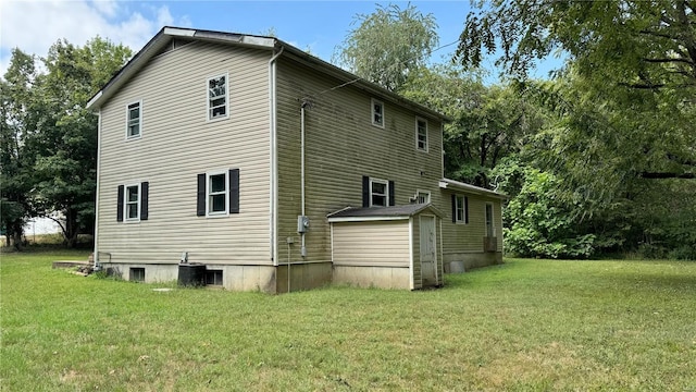 rear view of property featuring a lawn