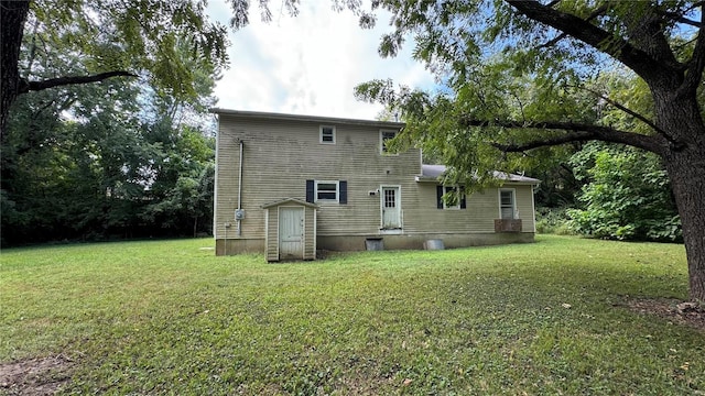 back of property with a lawn