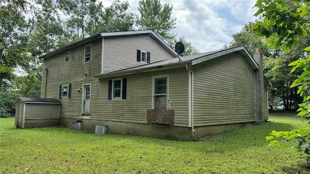 back of property featuring a yard