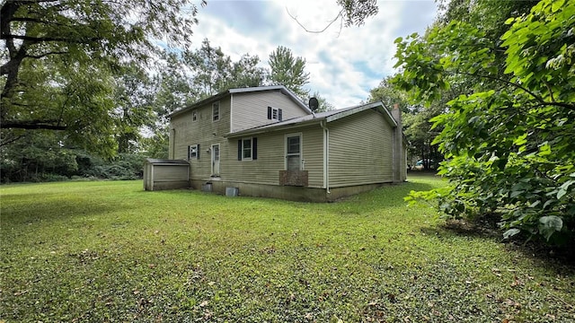 back of property featuring a lawn