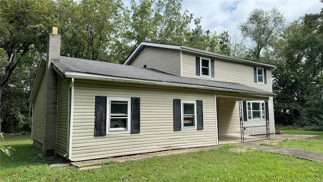 rear view of house with a lawn