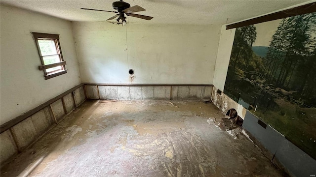 spare room with a textured ceiling and ceiling fan