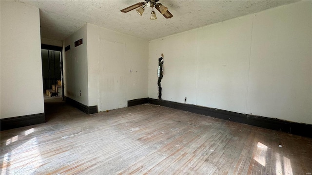 unfurnished room featuring ceiling fan and hardwood / wood-style flooring