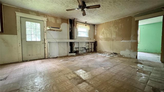 misc room featuring a textured ceiling, plenty of natural light, and ceiling fan