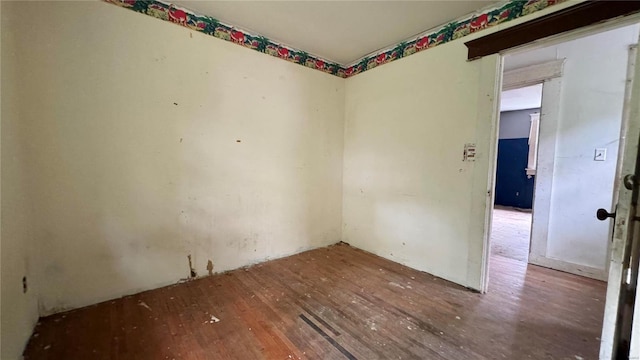 unfurnished room with wood-type flooring