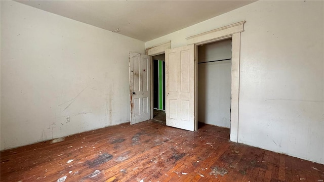 unfurnished bedroom with dark hardwood / wood-style floors