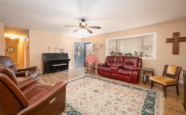 living room with light hardwood / wood-style floors and ceiling fan