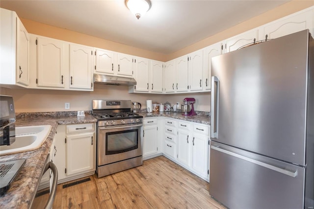 kitchen featuring white cabinetry, stainless steel appliances, sink, and light wood-type flooring