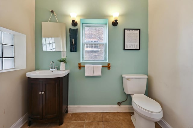 bathroom featuring tile patterned flooring, vanity, and toilet