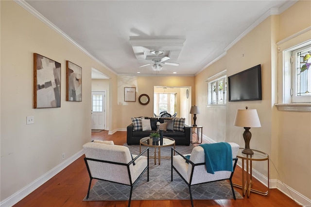 living room featuring dark hardwood / wood-style floors, ceiling fan, and crown molding